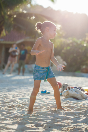 Boy playing flying disk on the beachの写真素材