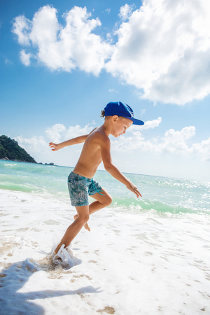 Cute boy is having fun on the beachの写真素材