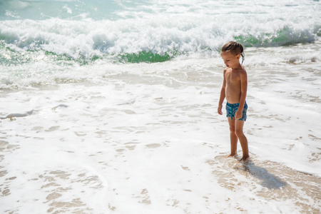 Cute boy is having fun on the beachの写真素材