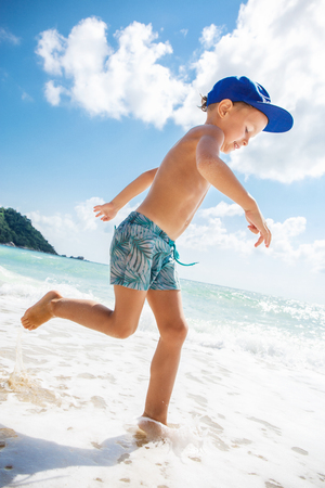 Cute boy is having fun on the beachの写真素材