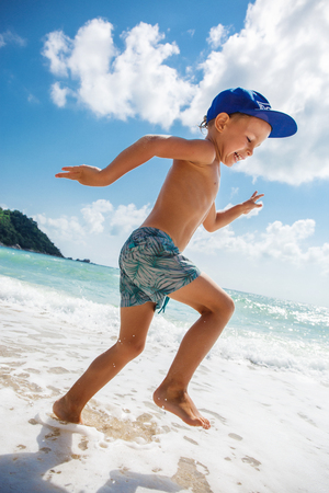 Cute boy is having fun on the beachの写真素材