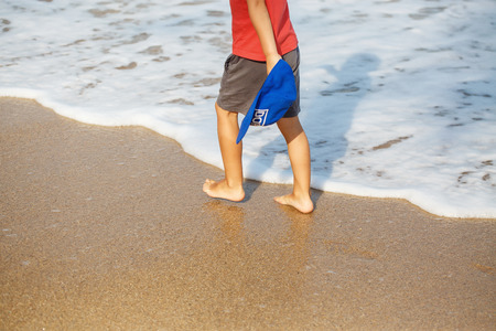 little legs of a boy walking on the beachの写真素材