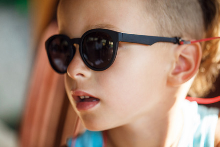 Portrait of a beautiful baby boy in sunglassesの写真素材