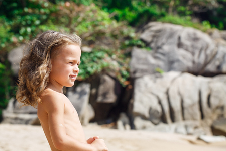 Little five years old boy is watching on the seaの写真素材