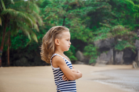 Little five years old boy is watching on the seaの写真素材
