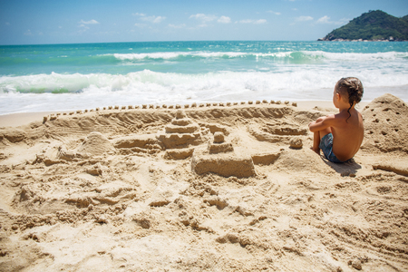 little boy built a sand castleの写真素材