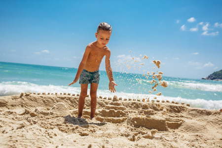 little boy built a sand castleの写真素材