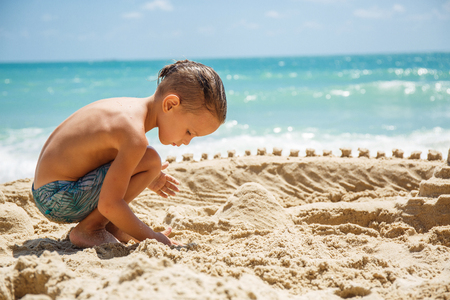 little boy built a sand castleの写真素材