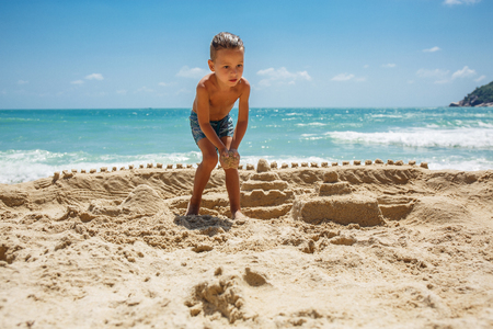 little boy built a sand castleの写真素材