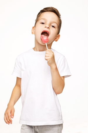 little boy with a lollipop on a white backgroundの写真素材