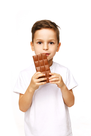 little beautiful boy holding chocolate studio shotの写真素材
