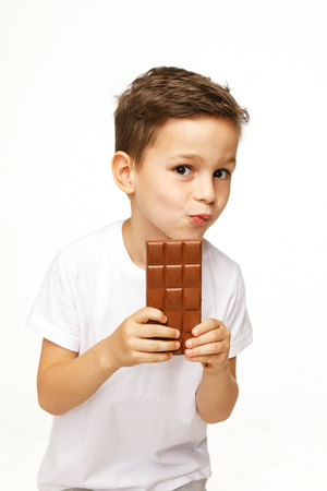 little beautiful boy holding chocolate studio shotの写真素材