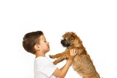 little boy in chocolate with his dogの写真素材