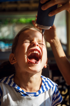 Little boy is drinking chocolate topping in Thailandの写真素材