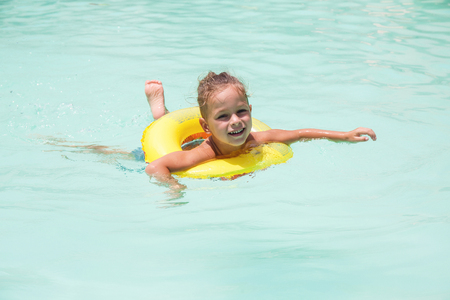 Baby boy is swimming in the poolの写真素材