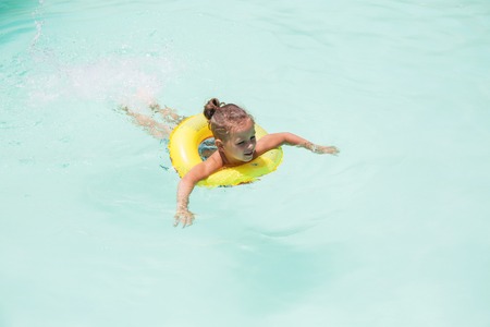 Baby boy is swimming in the poolの写真素材