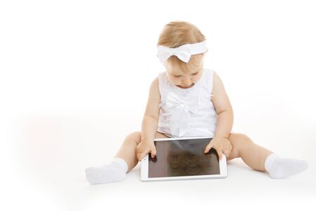little girl all in white with a tabletの写真素材