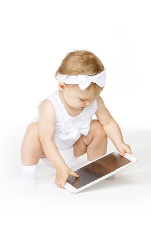 little girl all in white with a tabletの写真素材