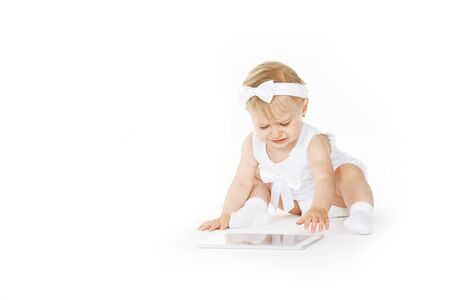 little girl all in white with a tabletの写真素材
