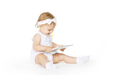 little girl all in white with a tabletの写真素材