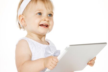 little girl all in white with a tabletの写真素材