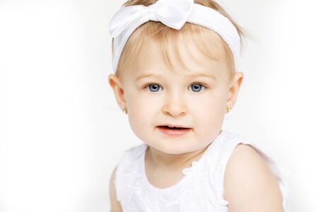 beautiful little girl all in white clothesの写真素材