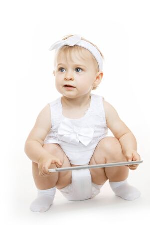 little girl all in white with a tabletの写真素材