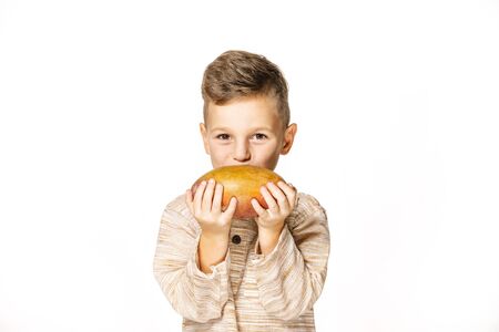 handsome pretty boy is holding mangoの写真素材