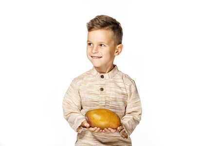 handsome pretty boy is holding a mangoの写真素材