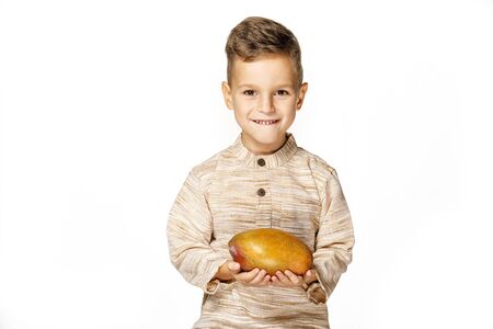 handsome pretty boy is holding a mangoの写真素材