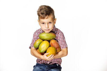 handsome boy in a red shirt with a mangoの写真素材