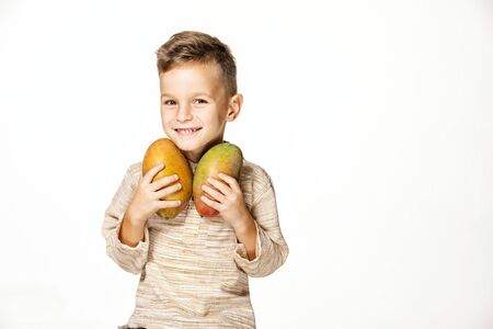 handsome pretty boy is holding a mangoの写真素材