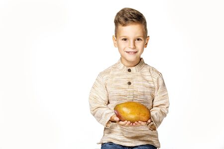 handsome pretty boy is holding a mangoの写真素材