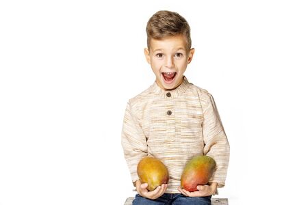 handsome pretty boy is holding a mangoの写真素材