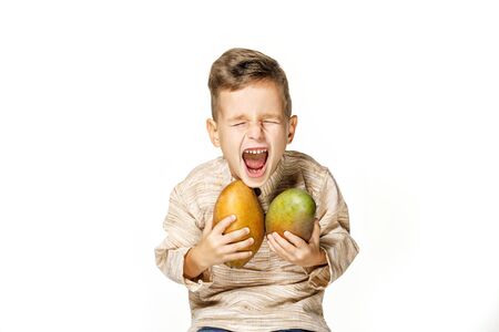 handsome pretty boy is holding a mangoの写真素材