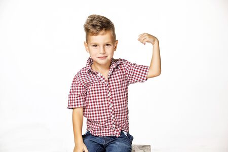 handsome boy shows his strength on white backgroundの写真素材
