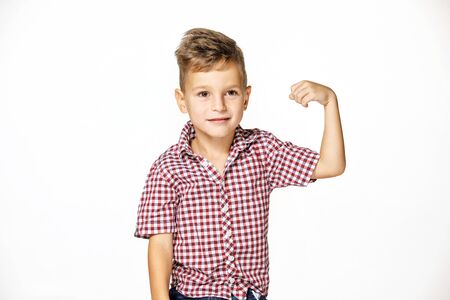 handsome boy shows his strength on white backgroundの写真素材