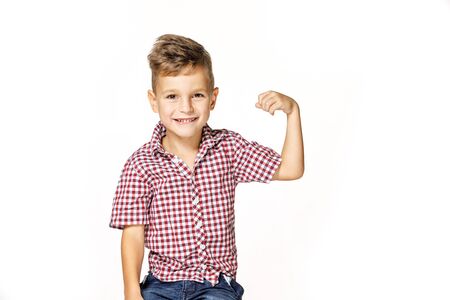 handsome boy shows his strength on white backgroundの写真素材