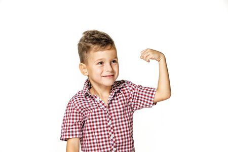 handsome boy shows his strength on white backgroundの写真素材