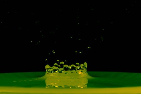 drop of water falling down in the waterの写真素材
