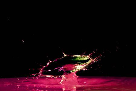 drop of water falling down in the waterの写真素材