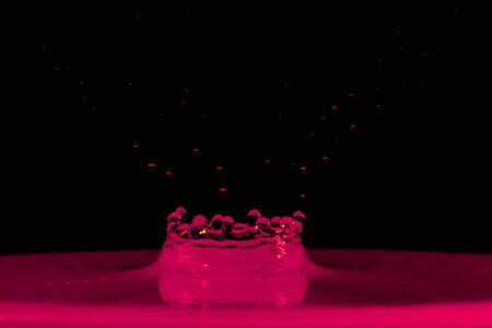 drop of water falling down in the waterの写真素材
