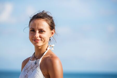 portrait of a beautiful girl in a white swimsuitの写真素材