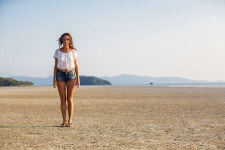 beautiful young girl on the background of a landscapeの写真素材