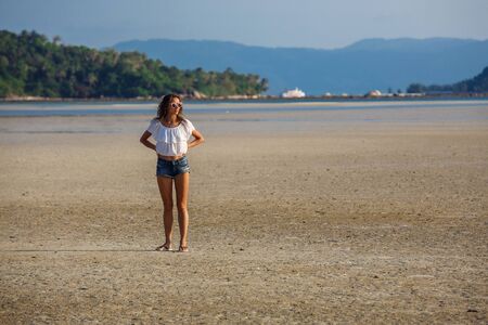 beautiful young girl on the background of a landscapeの写真素材