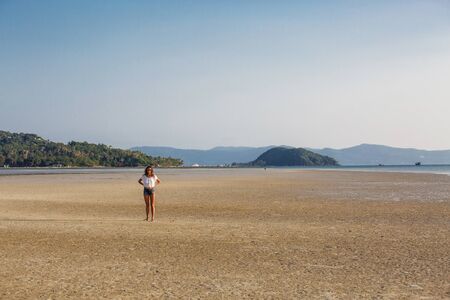 beautiful young girl on the background of a landscapeの写真素材