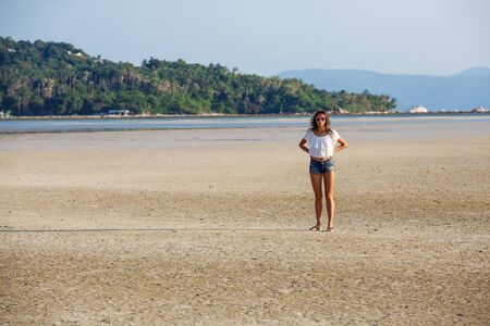 beautiful young girl on the background of a landscapeの写真素材