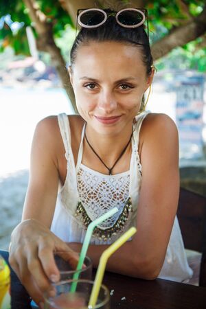beautiful girl in a white t-shirt in a cafeの写真素材
