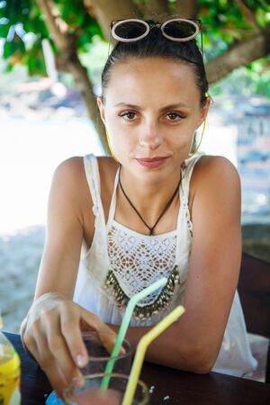 beautiful girl in a white t-shirt in a cafeの写真素材