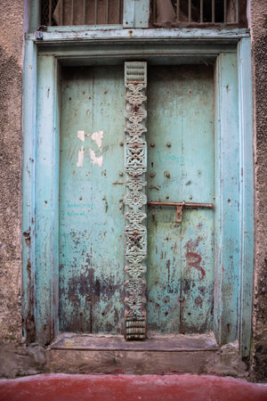Antique old wooden door. Beautiful colour. Bright sunny day.の写真素材